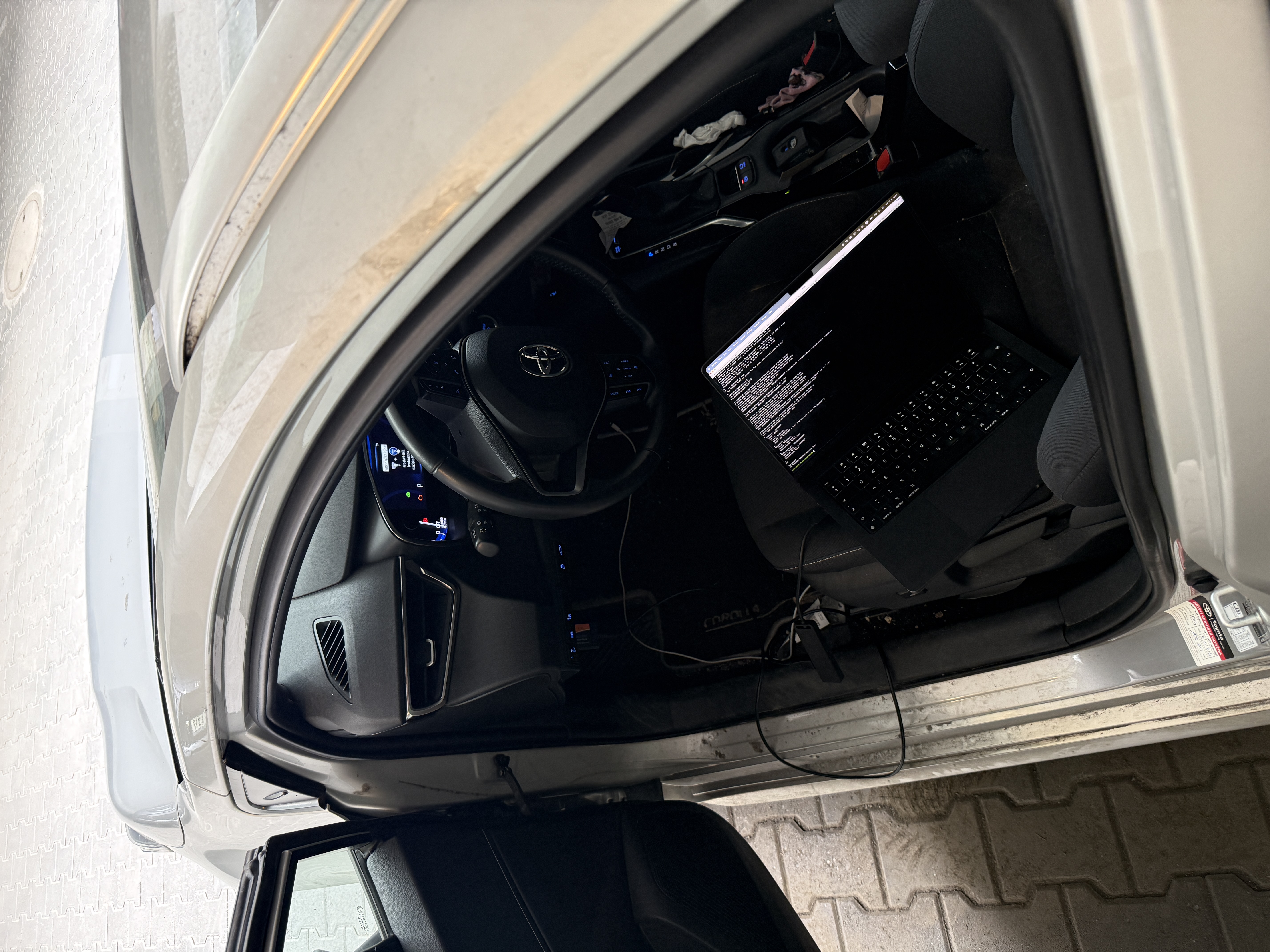 ELM327 cable running from the car's OBD-II port to the Raspberry Pi